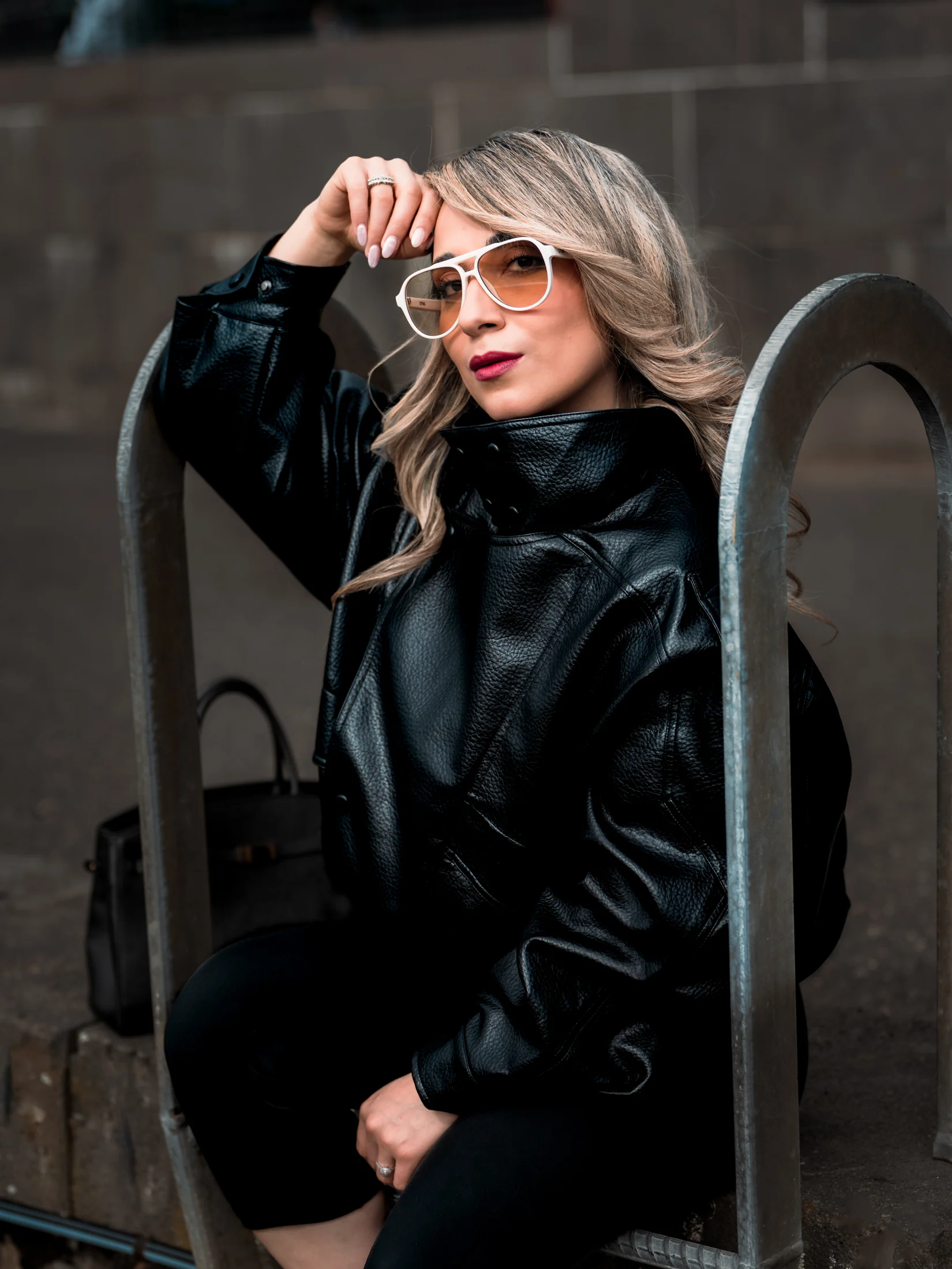 Portrait of Neda wearing a black jacket and white sunglasses