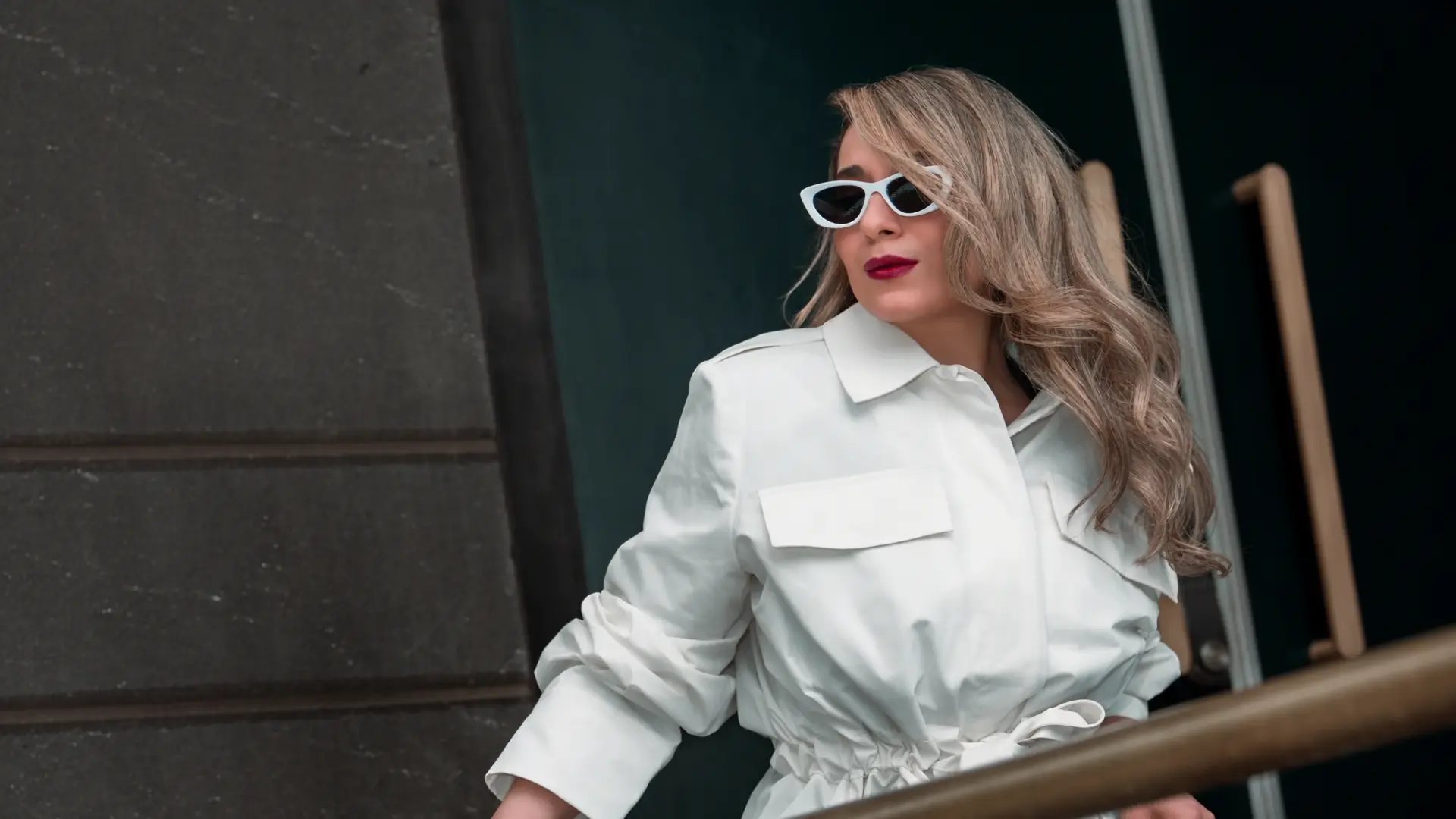 Neda in a white belted jacket, photographed on a Melbourne street